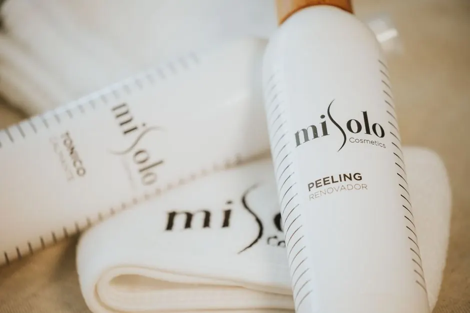 Close-up of MiSolo cosmetics skincare bottles and cloth for self-care.